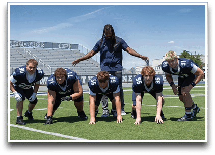 Three football players are standing on the field, one of them is smiling and wearing a black jersey with the number 55. AI generated content