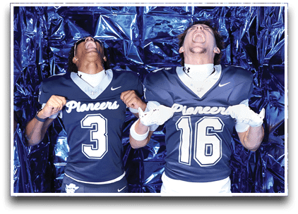 Three football players are standing on the field, one of them is smiling and wearing a black jersey with the number 55. AI generated content