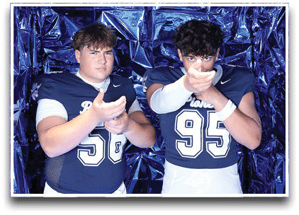 Three football players are standing on the field, one of them is smiling and wearing a black jersey with the number 55. AI generated content