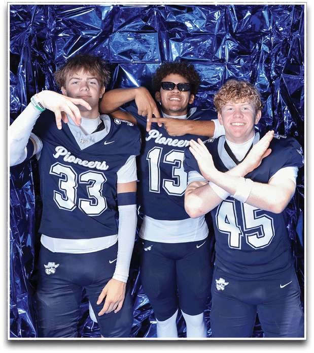 Three football players are standing on the field, one of them is smiling and wearing a black jersey with the number 55. AI generated content
