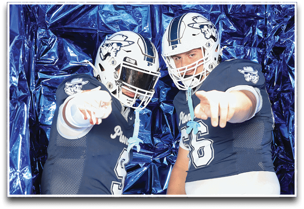 Three football players are standing on the field, one of them is smiling and wearing a black jersey with the number 55. AI generated content