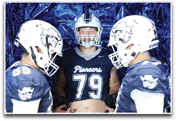 Three football players are standing on the field, one of them is smiling and wearing a black jersey with the number 55. AI generated content