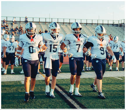 A football player wearing a blue and white uniform. Description generated by AI