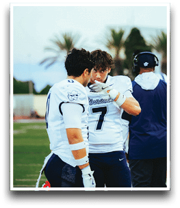 Three football players are standing on the field, one of them is smiling and wearing a black jersey with the number 55. AI generated content