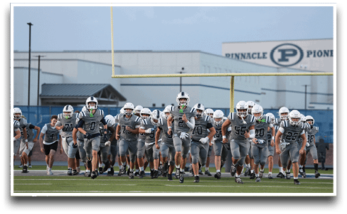 Three football players are standing on the field, one of them is smiling and wearing a black jersey with the number 55. AI generated content