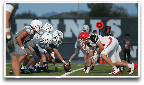 Three football players are standing on the field, one of them is smiling and wearing a black jersey with the number 55. AI generated content