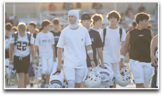 Three football players are standing on the field, one of them is smiling and wearing a black jersey with the number 55. AI generated content