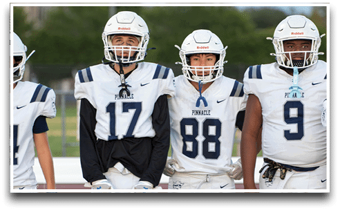 Three football players are standing on the field, one of them is smiling and wearing a black jersey with the number 55. AI generated content