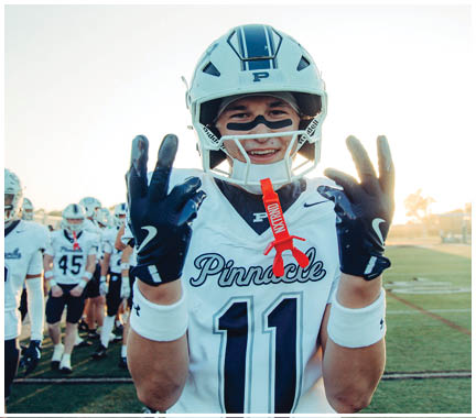 A football player wearing a blue and white uniform. Description generated by AI