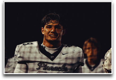 Three football players are standing on the field, one of them is smiling and wearing a black jersey with the number 55. AI generated content