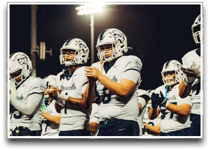 Three football players are standing on the field, one of them is smiling and wearing a black jersey with the number 55. AI generated content