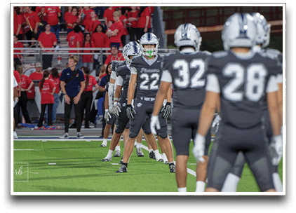 Three football players are standing on the field, one of them is smiling and wearing a black jersey with the number 55. AI generated content
