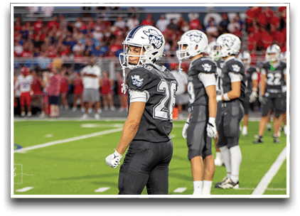 Three football players are standing on the field, one of them is smiling and wearing a black jersey with the number 55. AI generated content