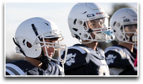 Three football players are standing on the field, one of them is smiling and wearing a black jersey with the number 55. AI generated content
