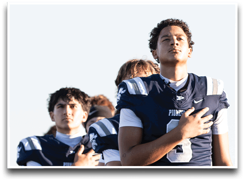 Three football players are standing on the field, one of them is smiling and wearing a black jersey with the number 55. AI generated content