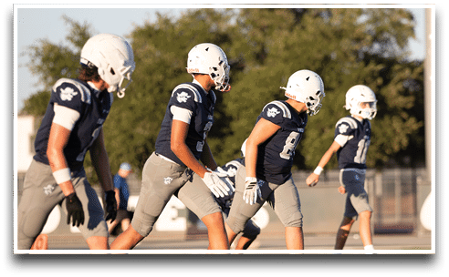 Three football players are standing on the field, one of them is smiling and wearing a black jersey with the number 55. AI generated content