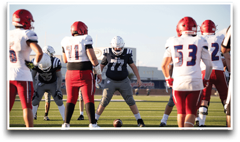 Three football players are standing on the field, one of them is smiling and wearing a black jersey with the number 55. AI generated content