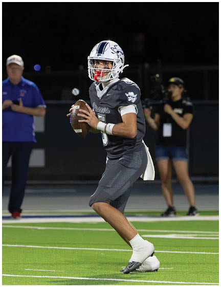 A football player wearing a blue and white uniform. Description generated by AI