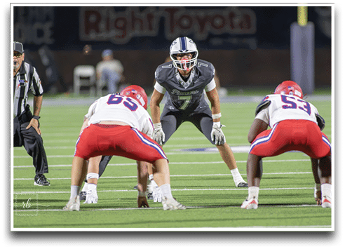 Three football players are standing on the field, one of them is smiling and wearing a black jersey with the number 55. AI generated content