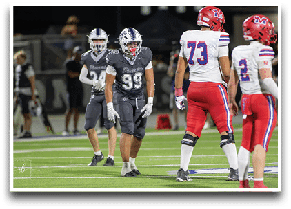 Three football players are standing on the field, one of them is smiling and wearing a black jersey with the number 55. AI generated content