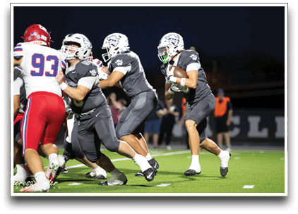 Three football players are standing on the field, one of them is smiling and wearing a black jersey with the number 55. AI generated content