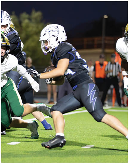 A football player wearing a blue and white uniform. Description generated by AI