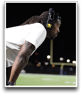 Three football players are standing on the field, one of them is smiling and wearing a black jersey with the number 55. AI generated content
