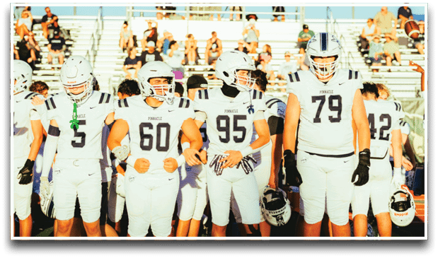 Three football players are standing on the field, one of them is smiling and wearing a black jersey with the number 55. AI generated content