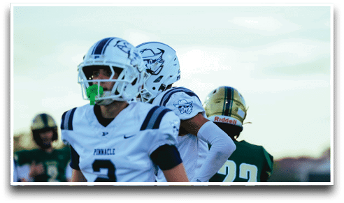 Three football players are standing on the field, one of them is smiling and wearing a black jersey with the number 55. AI generated content