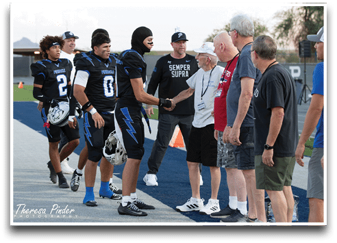 Three football players are standing on the field, one of them is smiling and wearing a black jersey with the number 55. AI generated content