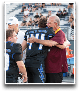 Three football players are standing on the field, one of them is smiling and wearing a black jersey with the number 55. AI generated content