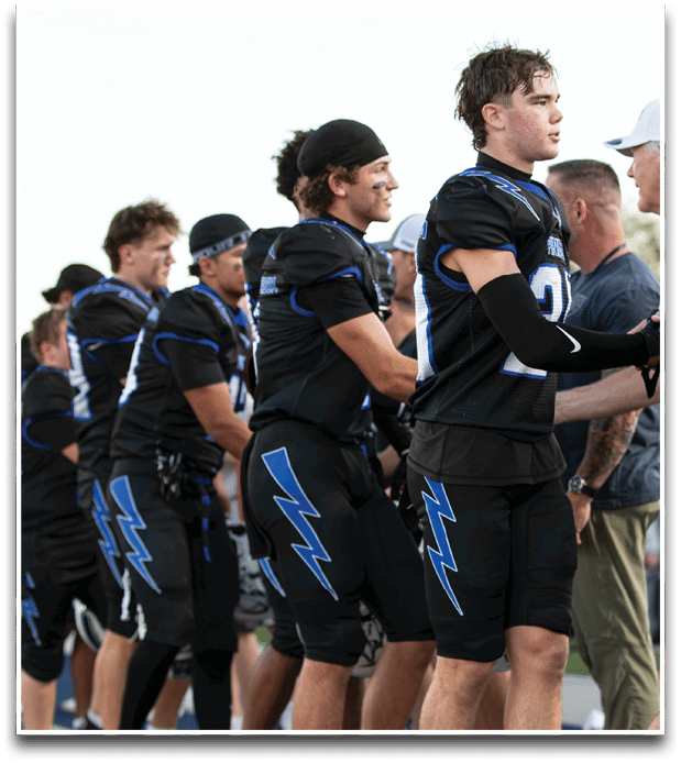 Three football players are standing on the field, one of them is smiling and wearing a black jersey with the number 55. AI generated content