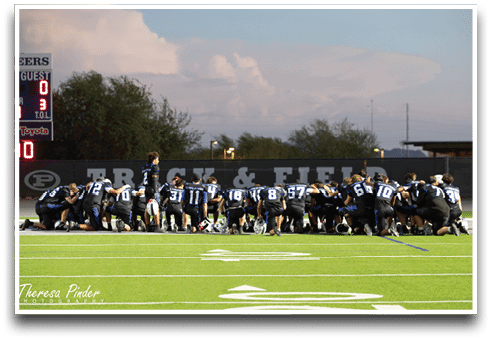 Three football players are standing on the field, one of them is smiling and wearing a black jersey with the number 55. AI generated content