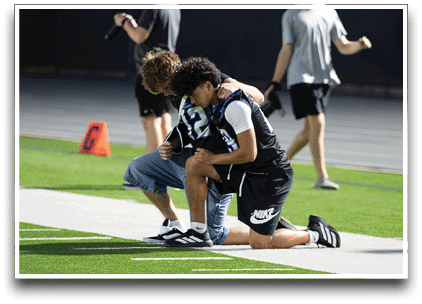 Three football players are standing on the field, one of them is smiling and wearing a black jersey with the number 55. AI generated content