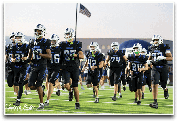 Three football players are standing on the field, one of them is smiling and wearing a black jersey with the number 55. AI generated content