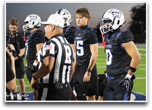 Three football players are standing on the field, one of them is smiling and wearing a black jersey with the number 55. AI generated content