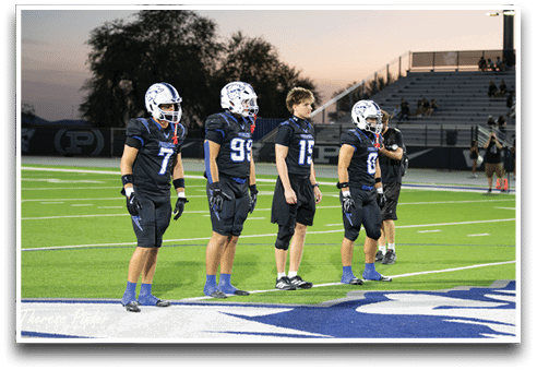 Three football players are standing on the field, one of them is smiling and wearing a black jersey with the number 55. AI generated content