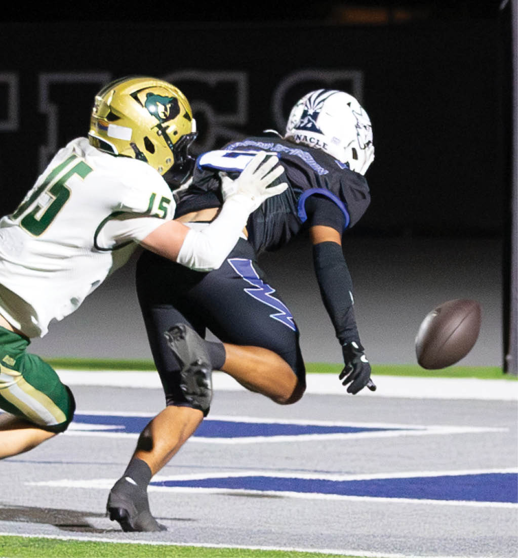 A football player running with a football. Description generated by AI