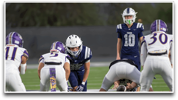 Three football players are standing on the field, one of them is smiling and wearing a black jersey with the number 55. AI generated content