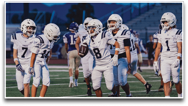 Three football players are standing on the field, one of them is smiling and wearing a black jersey with the number 55. AI generated content