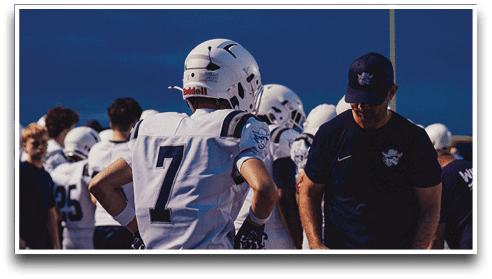 Three football players are standing on the field, one of them is smiling and wearing a black jersey with the number 55. AI generated content