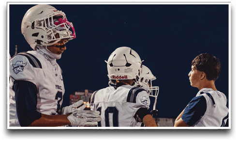 Three football players are standing on the field, one of them is smiling and wearing a black jersey with the number 55. AI generated content