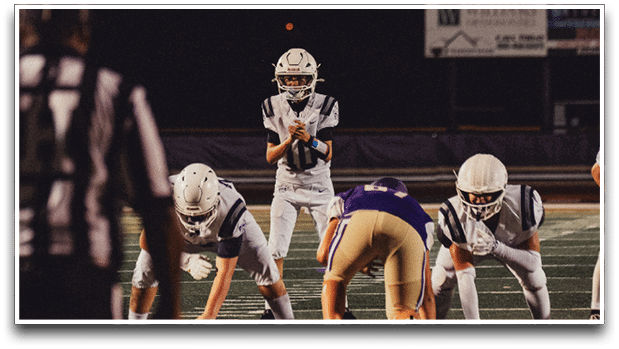 Three football players are standing on the field, one of them is smiling and wearing a black jersey with the number 55. AI generated content