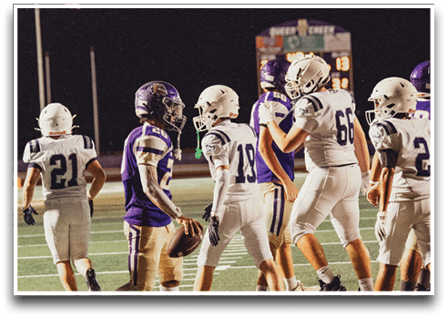 Three football players are standing on the field, one of them is smiling and wearing a black jersey with the number 55. AI generated content