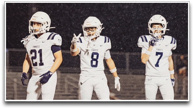 Three football players are standing on the field, one of them is smiling and wearing a black jersey with the number 55. AI generated content