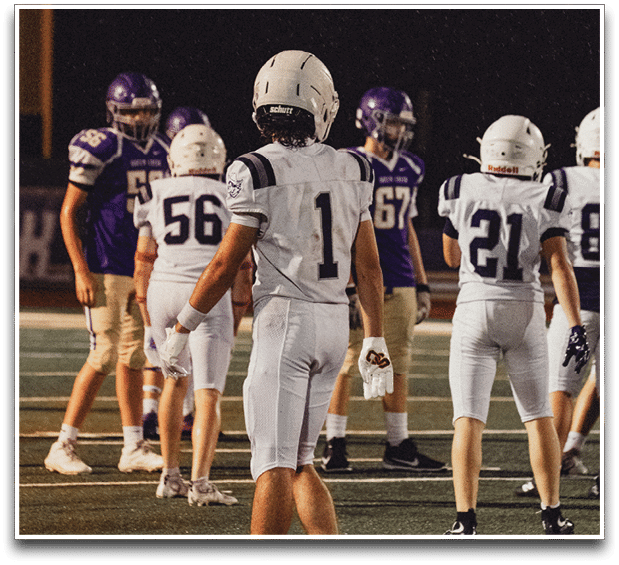 Three football players are standing on the field, one of them is smiling and wearing a black jersey with the number 55. AI generated content