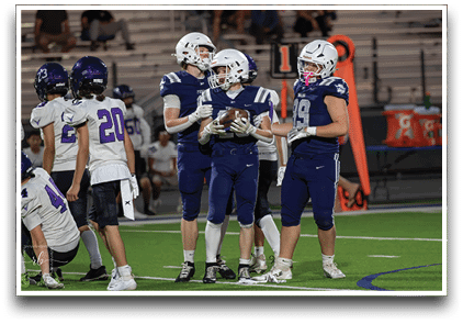 Three football players are standing on the field, one of them is smiling and wearing a black jersey with the number 55. AI generated content
