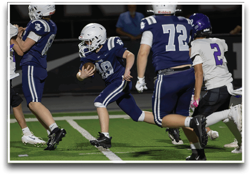 Three football players are standing on the field, one of them is smiling and wearing a black jersey with the number 55. AI generated content