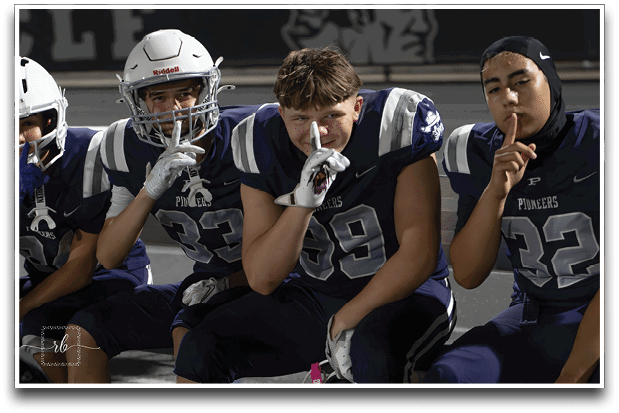 Three football players are standing on the field, one of them is smiling and wearing a black jersey with the number 55. AI generated content