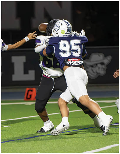 A football player wearing a blue and white uniform. Description generated by AI